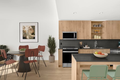 A modern kitchen with a dining table and chairs.