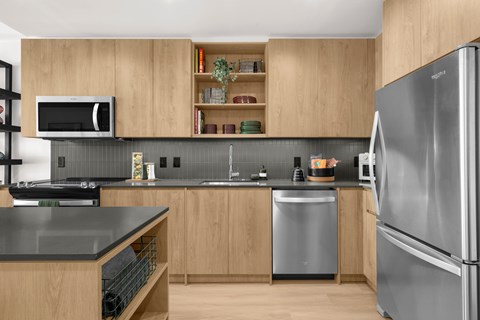 A modern kitchen with a refrigerator on the right.
