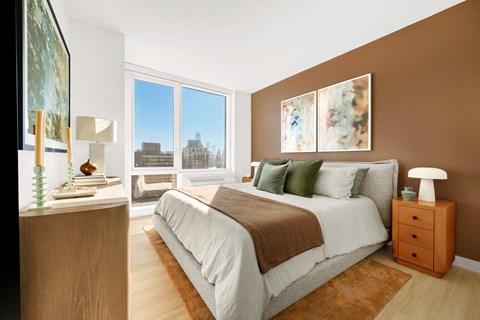 A bedroom with a large bed and a view of the city.