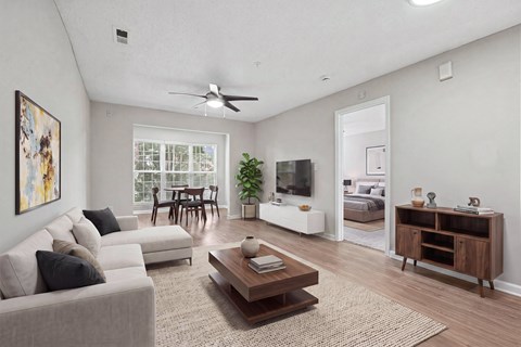 A living room with a grey couch, a brown coffee table, and a painting on the wall.