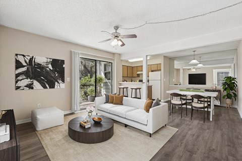 A living room with a white couch and a coffee table.