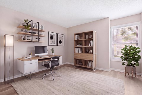 A room with a desk, chair, and bookshelf.