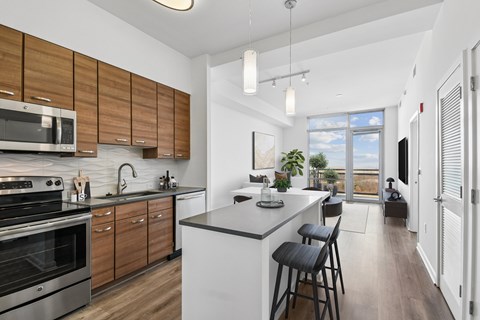 A modern kitchen with wooden cabinets and stainless steel appliances.