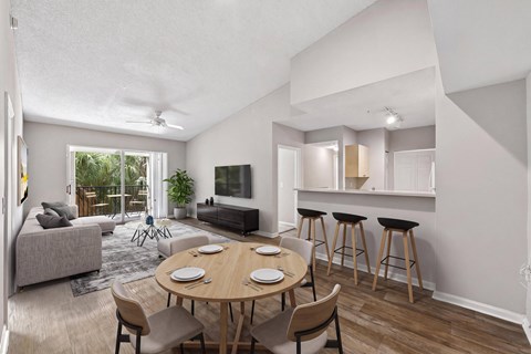 A modern living room with a dining table and chairs.