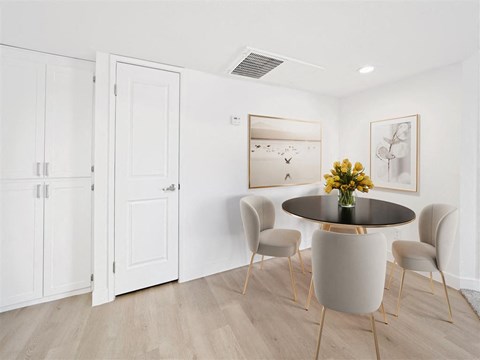 a dining room with a table and chairs