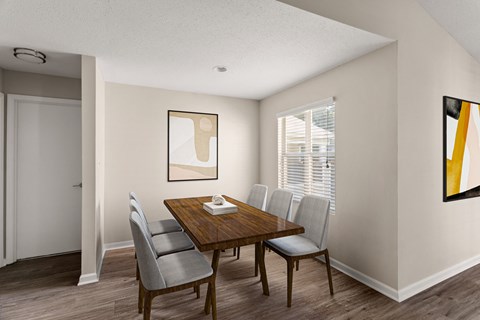 a dining room with a table and chairs