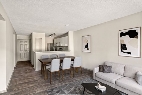A modern living room with a dining table and chairs.