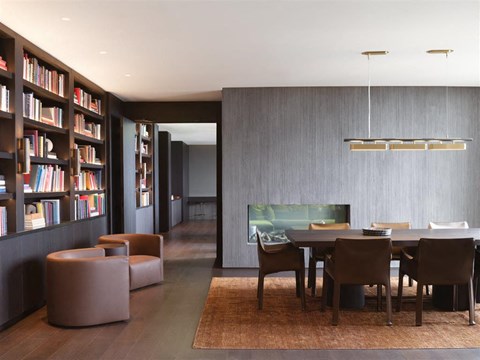 A modern dining room with a large table and chairs.