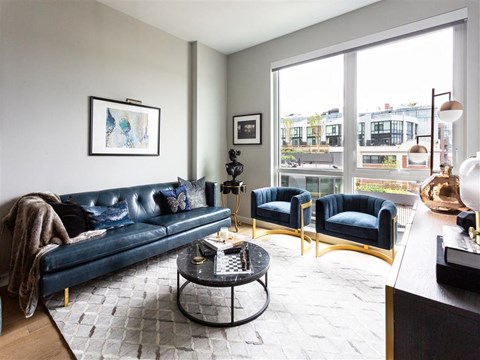A living room with a blue couch and a coffee table.