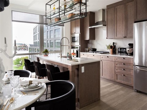 A modern kitchen with a dining table set for four.