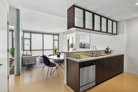 A modern kitchen with a dining table and chairs.