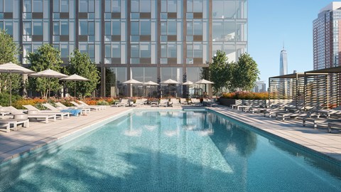 A large swimming pool with a cityscape in the background.