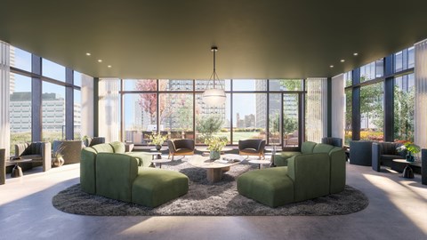 A modern living room with green sofas and a large window.