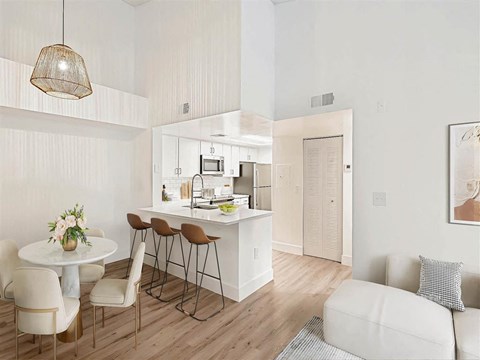 A modern kitchen with a dining table and chairs.