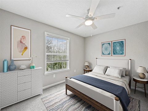 A bedroom with a bed, nightstand, and a ceiling fan.