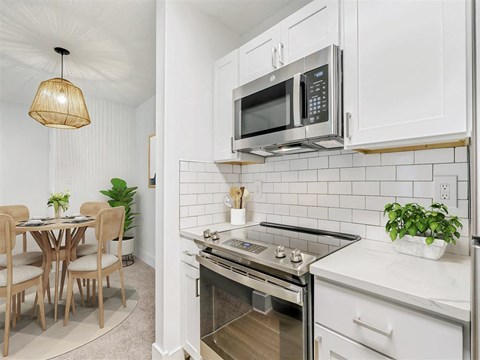 A kitchen with a stove top oven and microwave above it.