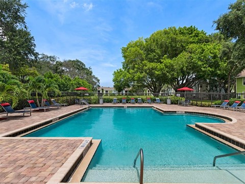 a large swimming pool with chairs in it
