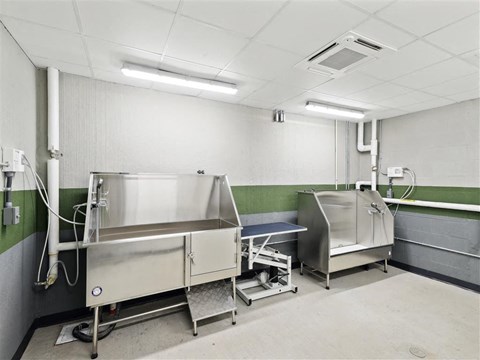 a kitchen with two stainless steel sinks and a table