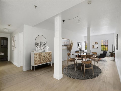 a living room and dining room with a table and chairs