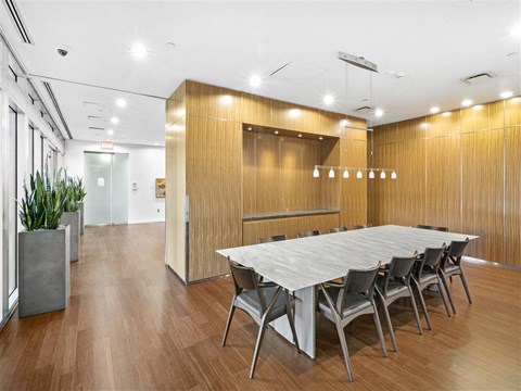 A conference room with a long table and chairs.