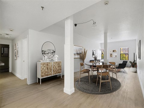 A modern dining room with a round table and chairs.