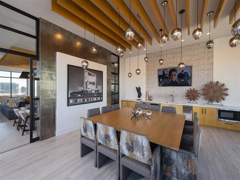A modern dining room with a wooden table and chairs.