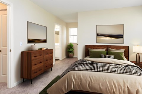 A bedroom with a bed, dresser, and mirror.