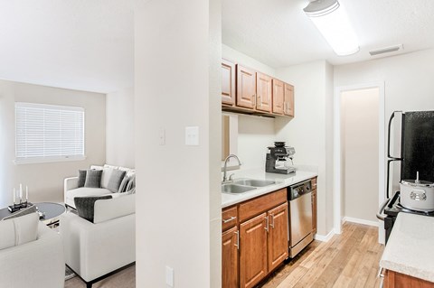 A kitchen with wooden cabinets and a white countertop.