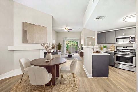 A modern kitchen with a dining table and chairs.