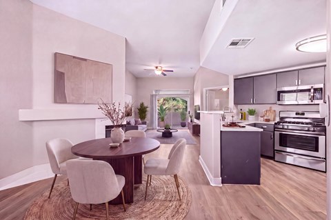 A modern kitchen with a dining table and chairs.