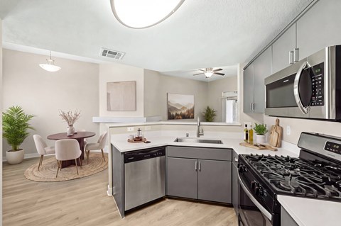 A modern kitchen with a stainless steel dishwasher and oven.
