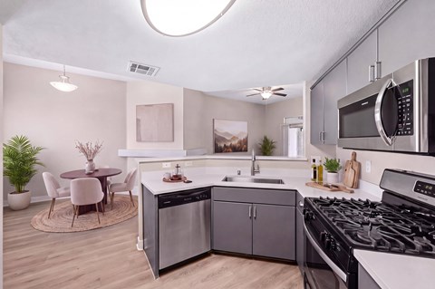 A modern kitchen with a dining table and chairs.