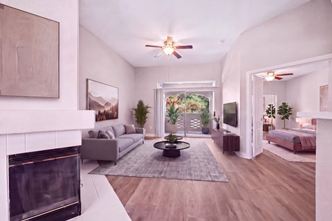 A modern living room with a fireplace and a large window.
