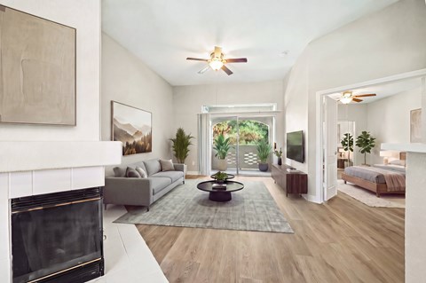 A modern living room with a fireplace and a large window.