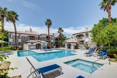 our apartments have a large swimming pool and a patio with chairs