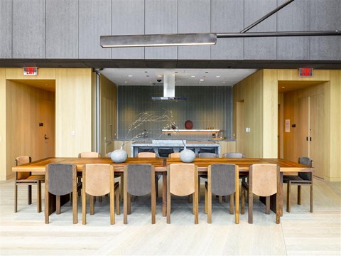 A modern dining room with a wooden table and chairs.