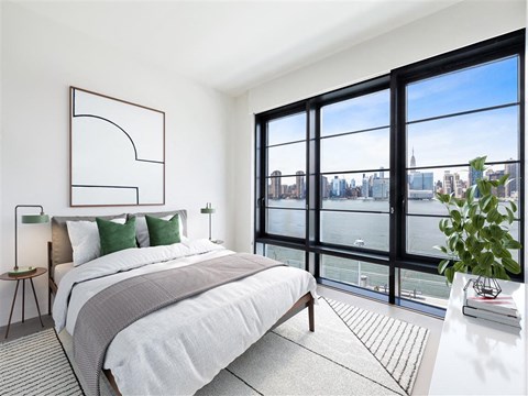 a bedroom with a bed and a view of a river