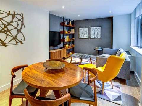 a living room with a table and chairs