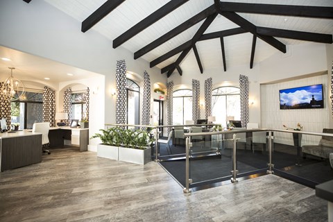 a large lobby with a bar and a tv