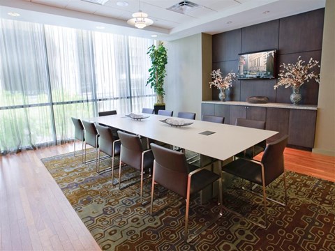 A conference room with a long table and chairs.