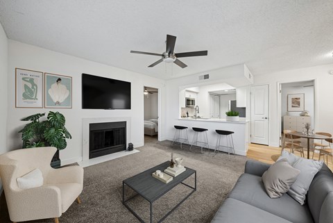 A living room with a fireplace, a couch, a chair, and a coffee table.