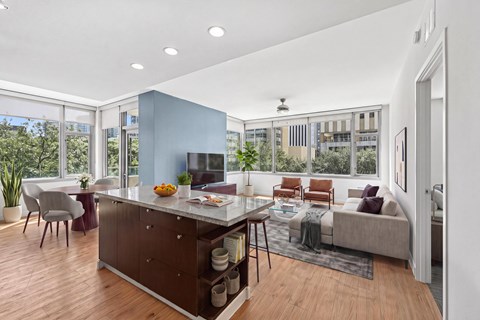 A modern kitchen with a dining table and chairs.