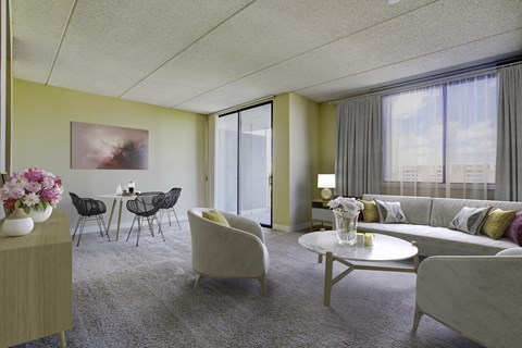 a living room with a couch and chairs and a table