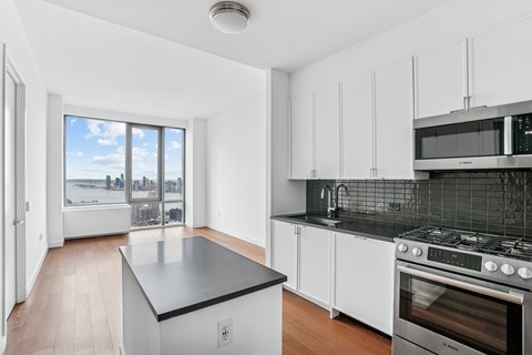 A kitchen with a stove top oven and a counter top.