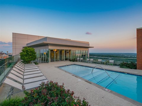a swimming pool with a building in the background