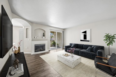 A modern living room with a fireplace and a large TV.