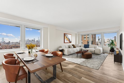 A modern living room with a dining table set for two.