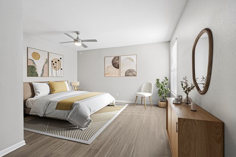 A bedroom with a bed, chair, and artwork on the wall.