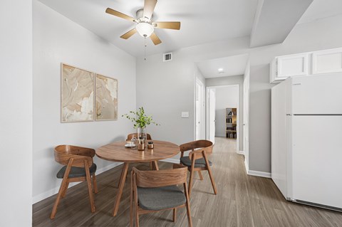 A dining room with a table and chairs.