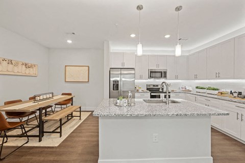A kitchen with a dining table and chairs.